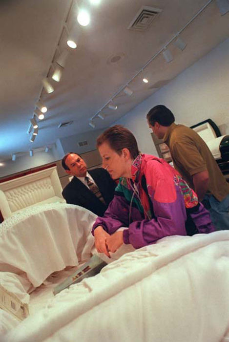 Third Place, Feature Picture Story - Jocelyn Williams / Akron Beacon JournalBruce Redmon at left watches as Tobie Cozy Reed decides on a casket.  Tobie's husband Matt is in background.  Tobie chose this cherry wood casket.