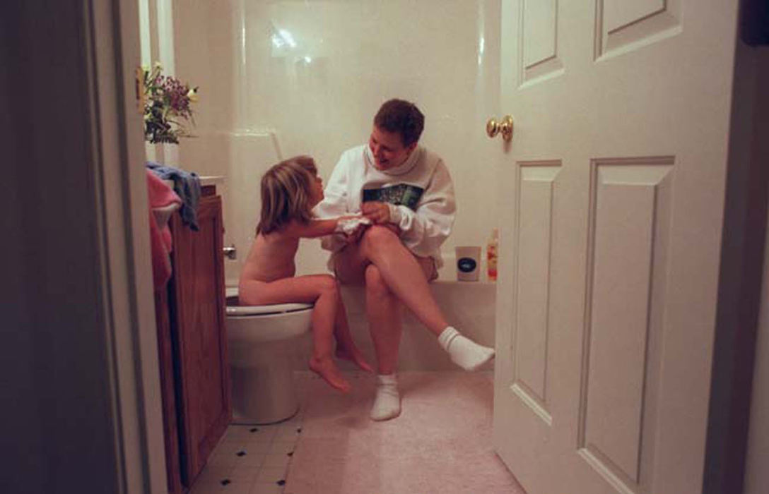 Third Place, Feature Picture Story - Jocelyn Williams  / Akron Beacon JournalTobie helps her daughter Julia get ready for bed. After brushing her teeth,  Julia goes to the potty as mom prepares her for bed.