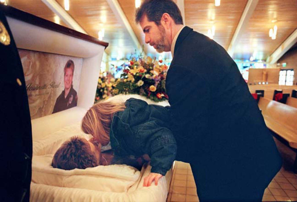 Third Place, Feature Picture Story - Jocelyn Williams / Akron Beacon JournalJulia Cozy, 5, kisses her mom goodbye as she is being held up by her dad Mark Cozy (Tobie's first husband) at Holy Family Church in Stow.