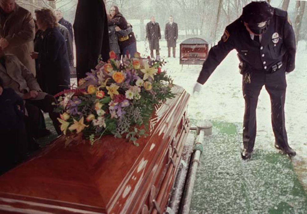 Third Place, Feature Picture Story - Jocelyn Williams / Akron Beacon JournalA fellow police officer whispers words to Tobie and taps her casket at the end of the graveside service.