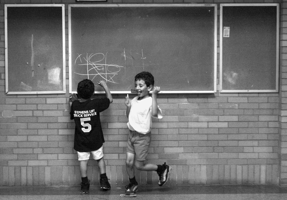 Award of Excellence, Feature Picture Story - Bob DeMay / Akron Beacon JournalJavier and his brother Eric, play tic tac toe while their mother Marie takes English lessons at a local church. The children attend public schools and are fluent in English.