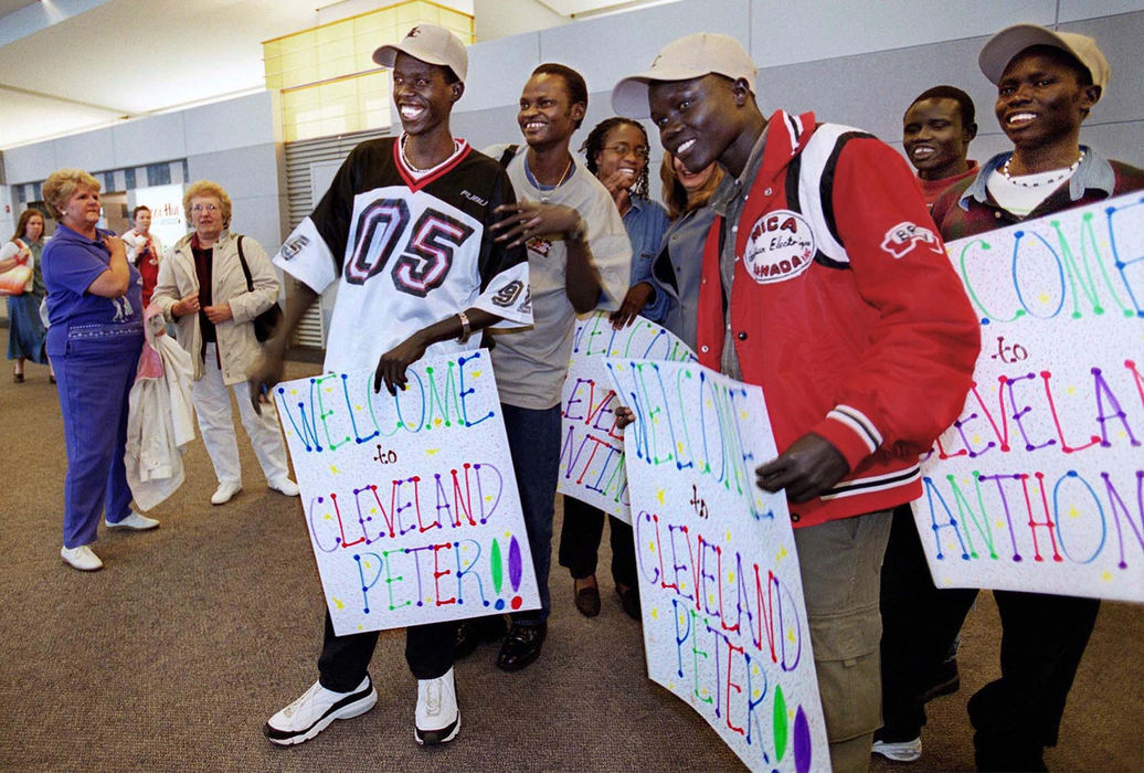 Award of Excellence, Feature Picture Story - Lynn Ischay / The Plain DealerWith each newly arriving Sudanese, the men become more of a family in their new homeland. Those already in Cleveland strain for a first glimpse of familiar faces coming off the plane from Kakuma, Kenya. This day will reunite Makol with his cousin, Peter Alier. 