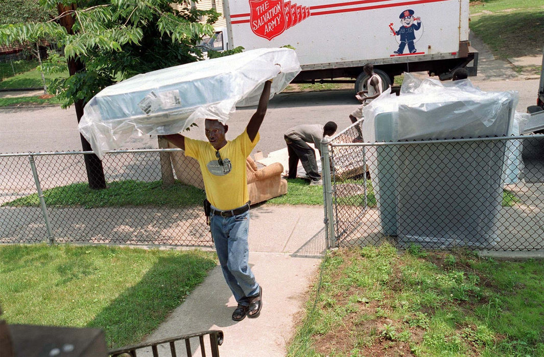 Award of Excellence, Feature Picture Story - Lynn Ischay / The Plain DealerNgorAguen helps his Sudanese brothers move from their transition house into a new apartment in Cleveland's inner city. 