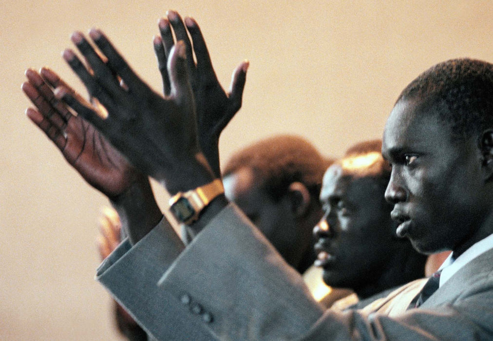 Award of Excellence, Feature Picture Story - Lynn Ischay / The Plain DealerReligion is a comfort for Ngor Akok Aguen, right, who worships at St. Agnes Church every Sunday.  Aguen is the first of 40 Sudanese refugees  brought to Cleveland from Kakuma, Kenya, by Cleveland Catholic Charities. 