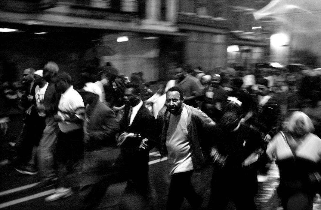 Award of Excellence, General News - Steven M. Herppich / Cincinnati EnquirerMarching for Justice-Protestors from New Prospect Baptist Church link arms as they lead a protest march up Vine Street from District 1 Headquarters in Cincinnati after the press conference releasing the Grand Jury's findings in the Stephen Roach shooting of Timothy Thomas Monday night, May 7, 2001. Officer Roach was indicted on the least serious charges possible in the shooting death of Mr. Thomas. 