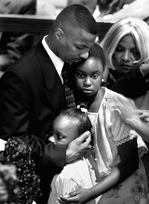 First Place, News Picture Story - Steven M. Herppich / Cincinnati EnquirerFamily members say farewell at the funeral of Timothy Thomas at Prospect Baptist Church on Elm Street in Over-the-Rhine Saturday afternoon, April 15, 2001. Timothy Thomas was fatally shot last weekend by  Cincinnati Police officer Stephen Roach.