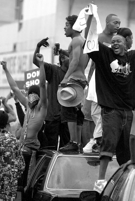 Second Place, News Picture Story - Michael E. Keating / Cincinnati EnquirerProtestors stand atop cars as they march through the streets in protest of alleged police abuses.