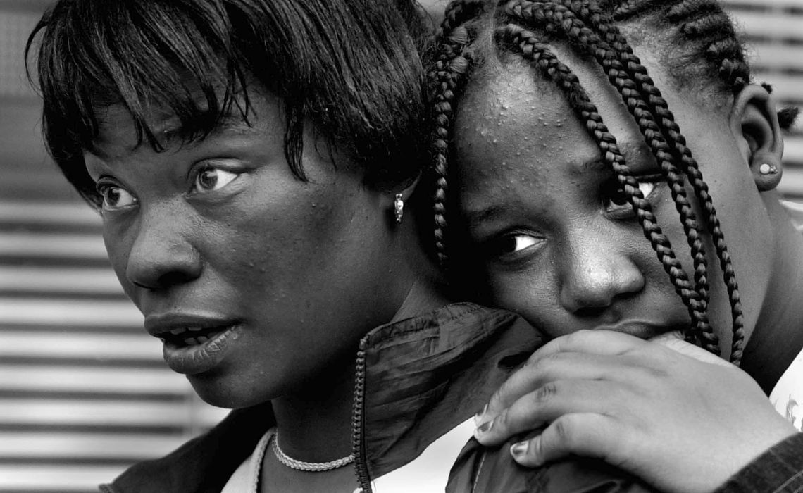 Second Place, News Picture Story - Michael E. Keating / Cincinnati EnquirerTwo teen girls watch from a safe vantage point as police form a barrier line to begin the roundup of violent protestors in their neighborhood.