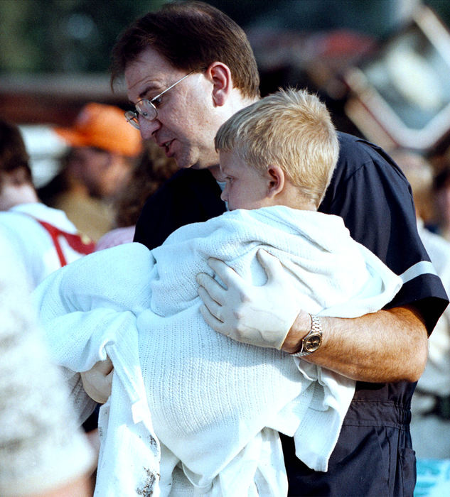 Third Place, News Picture Story - Shirley Ware / The Medina GazetteA paramedic wraps a blanket around a young boy and carries him to a waiting ambulance.