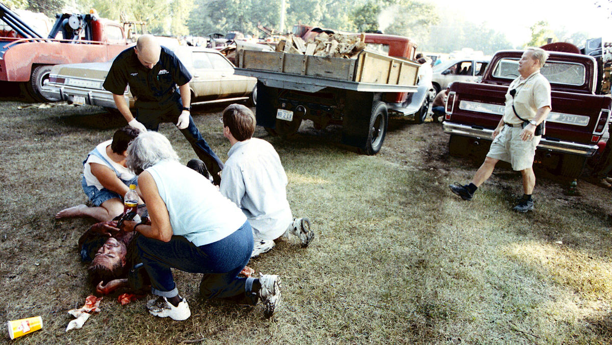 Third Place, News Picture Story - Shirley Ware / The Medina GazetteCivilians help a victim of the Case steam engine explosion before medical responders arrive on the scene.