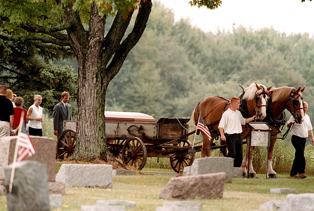 Third Place, News Picture Story - Shirley Ware / The Medina GazetteA pair of Belgian horses pulling a wagon are led through Litchfield Cemetery carrying Dennis Jungbluth's casket. His children followed immediately behind. Dennis was one of five who died at the explosion of the steam engine at The Medina County Fairgrounds.