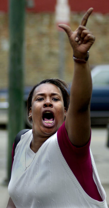 Award of Excellence, News Picture Story - Brandi Stafford / The Cincinnati EnquirerA woman screams at Cincinnati police officers as rioters took to the streets to protest the shooting death of an unarmed black man by a white Cincinnati police officer. 