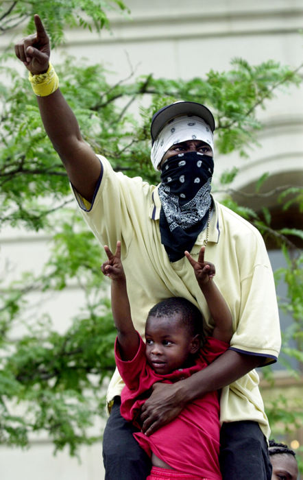 Award of Excellence, News Picture Story - Brandi Stafford / The Cincinnati EnquirerLife Allah holds onto 4-year-old Elijah Richmond while standing high on the steps of the Hamilton County Courthouse as the Grand Jury releases their findings of officer Stephen Roach's shooting death of Timothy Thomas. 