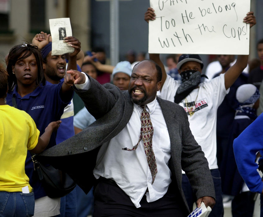 Award of Excellence, News Picture Story - Brandi Stafford / The Cincinnati EnquirerA man expresses his anger towards a line of Cincinnati police officers blocking the path of marchers protesting the shooting death of an unarmed black man by a white Cincinnati police officer. 