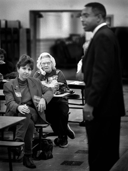 Award of Excellence, News Picture Story - Dale Omori / The Plain DealerCleveland mayoral candidate Raymond Pierce talks to a meeting of the Ward 18 Democrats at St. Ignatius Church on Cleveland's West Side.  Campbell supporters Lynn Parry and June Eiffel listen but seem unconvinced.