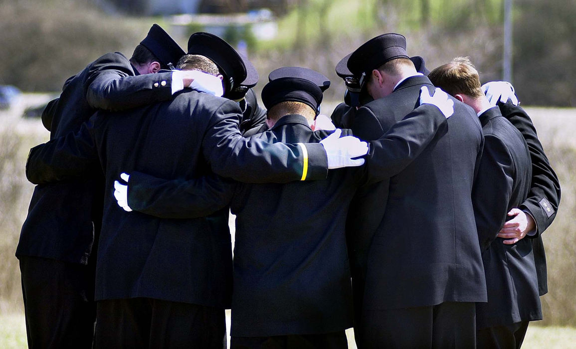 Award of Excellence, News Picture Story - Glenn Hartong / The Cincinnati EnquirerAnderson Township firefighters gather and hug after firefighter/paramedic William "Doc" Ellison's burial at St. Stephen Cemetery in Fort Thomas Kentucky.