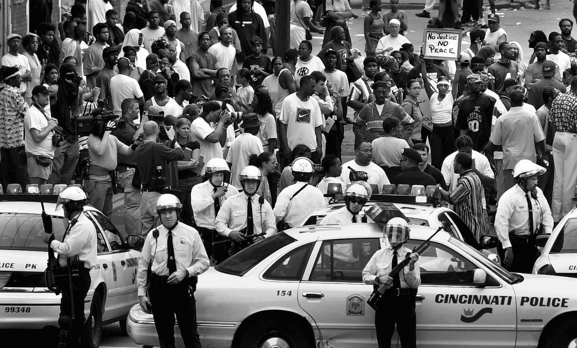 First Place, News Picture Story - Steven M. Herppich / Cincinnati EnquirerPolice block a crowd gathered at 13th Street and Republic near the sight of the shooting of Timothy Thomas by a Cincinnati Police Officer. A Black Panther gathering was scheduled at the sight at 3:30 pm. Eventually the police backed off their vehicles and let the march commence. 