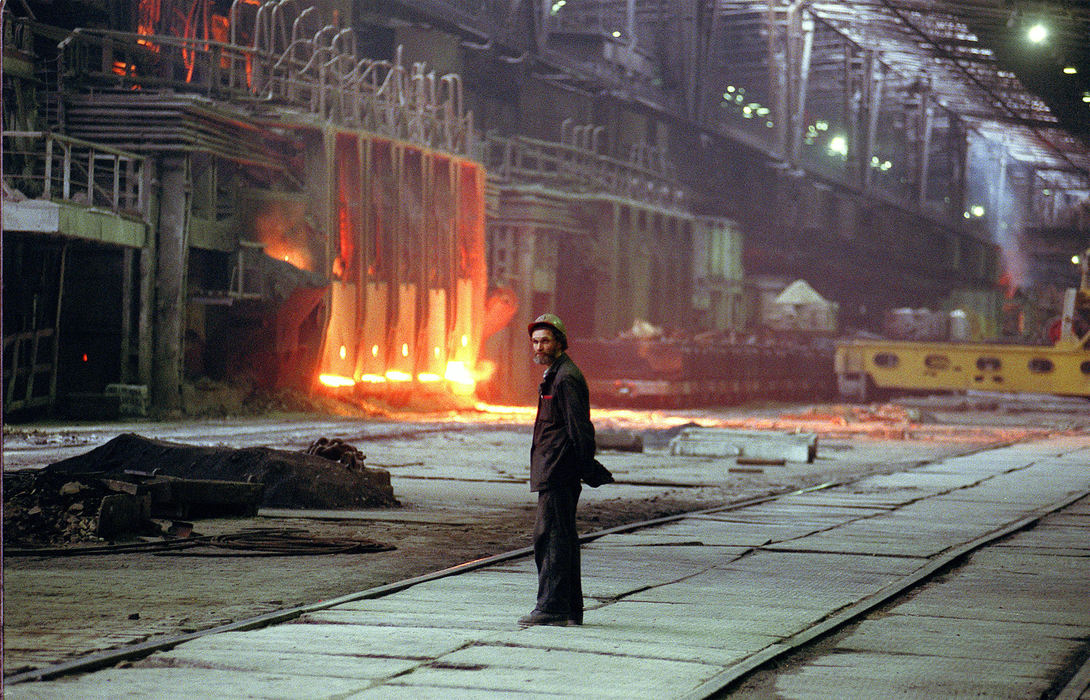 First Place, Ohio Understanding Award - Mike Levy / The Plain DealerA Severstal worker waits for an open-hearth furnace to produce a batch of molten iron. Severstal has closed 10 of its 12 open-hearth furnaces, which are inefficient and antiquated by American standards. Open-hearth take eight hours to make a batch of steel. Severstal's modern furnaces take just 50 minutes.