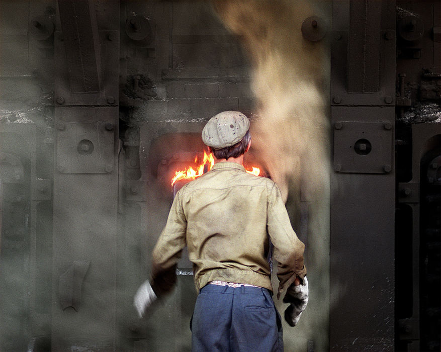 First Place, Ohio Understanding Award - Mike Levy / The Plain DealerA worker tends a coke oven at Severstal's plant in Chere povets. Coke, coal that has been processed to remove impurities, is consumed in blast furnaces while smelting iron.