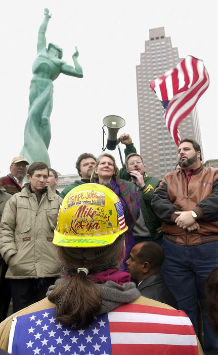 First Place, Ohio Understanding Award - Scott Shaw / The Plain DealerLTV steelworker Mike Kostya listens to rally speakers after steelworkers and supporters marched from St. Michael Hospital to the Veterans Peace Memorial,  Dec. 1, 2001, in downtown Cleveland. Speakers (from left) include Rep. Dennis Kucinich, Cleveland City Council member Joseph Cimperman, Mark Shaw, United Steelworkers of America, Cleveland Mayor-elect Jane Campbell, John Ryan, AFL-CIO, and County Commisioner Jimmy DiMora. 