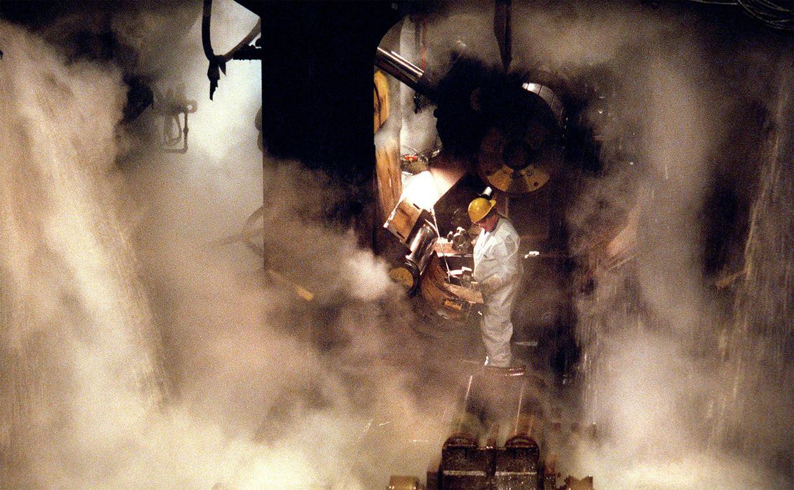 First Place, Ohio Understanding Award - Dale Omori / The Plain Dealer A steelworker at LTV's Cleveland Works, left, does maintenance earlier this month on the machine that coils steel. With excess supply flooding the market, many industry watchers say the death of one or more big American steel makers is inevitable, even desirable.