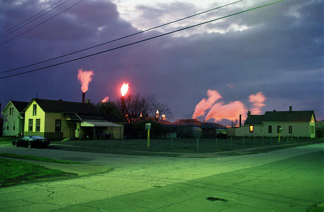 First Place, Ohio Understanding Award - Mike Levy / The Plain DealerThe sun setting casts a redish light on the back lit smoke from LTV. The green cast on the street is from a street lamp.  The mill was the life - the breath - of this neighborhood, at East 45th and Jewett.