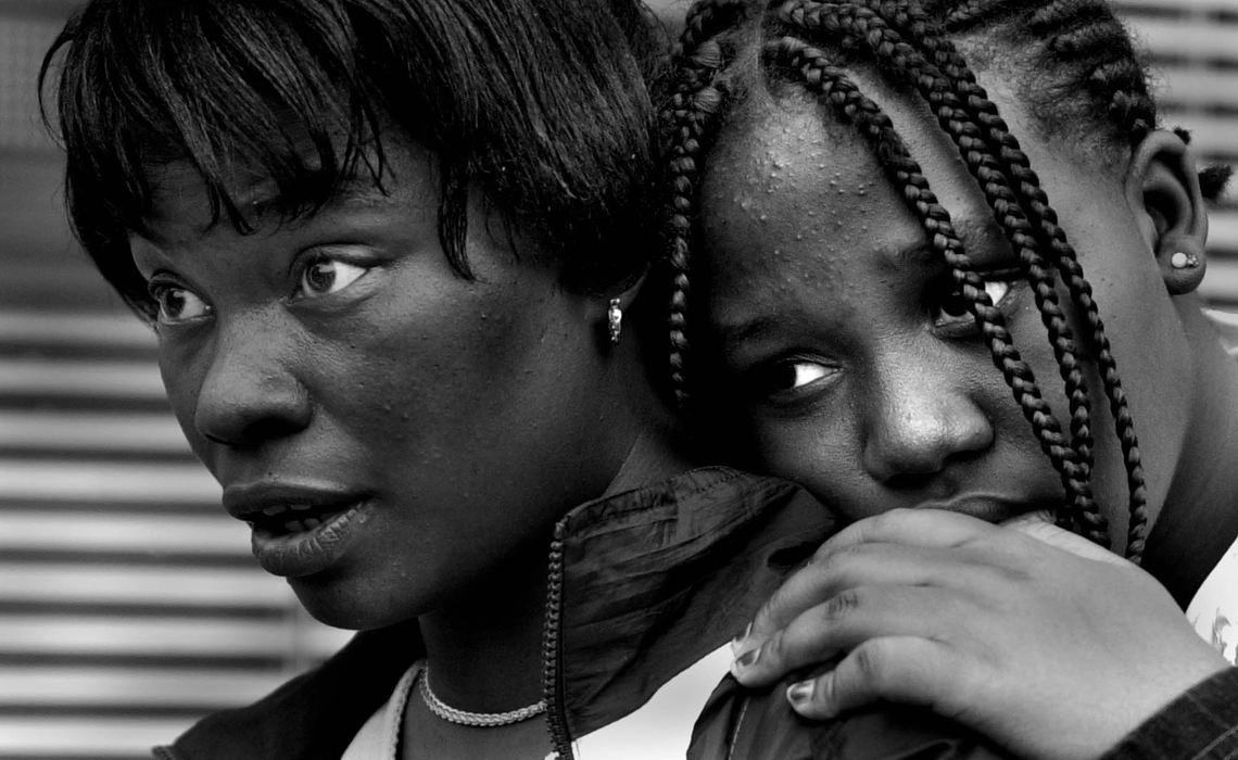 Third Place, Photographer of the Year - Michael E. Keating / Cincinnati EnquirerTwo teen girls watch from a safe vantage point as police form a barrier line to begin the roundup of violent protestors in their neighborhood.