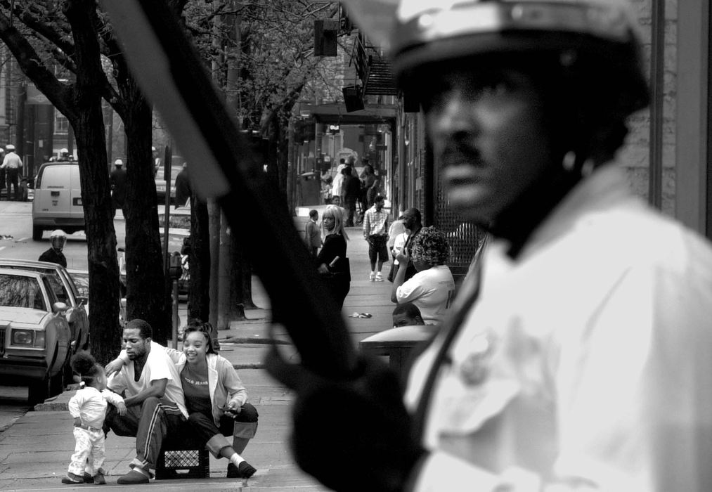 Third Place, Photographer of the Year - Michael E. Keating / Cincinnati EnquirerWith police in riot gear in place to keep the calm a mother, father and young daughter take up a curbside vantage point to watch the action unfold. Police presence on the streets is commonplace.