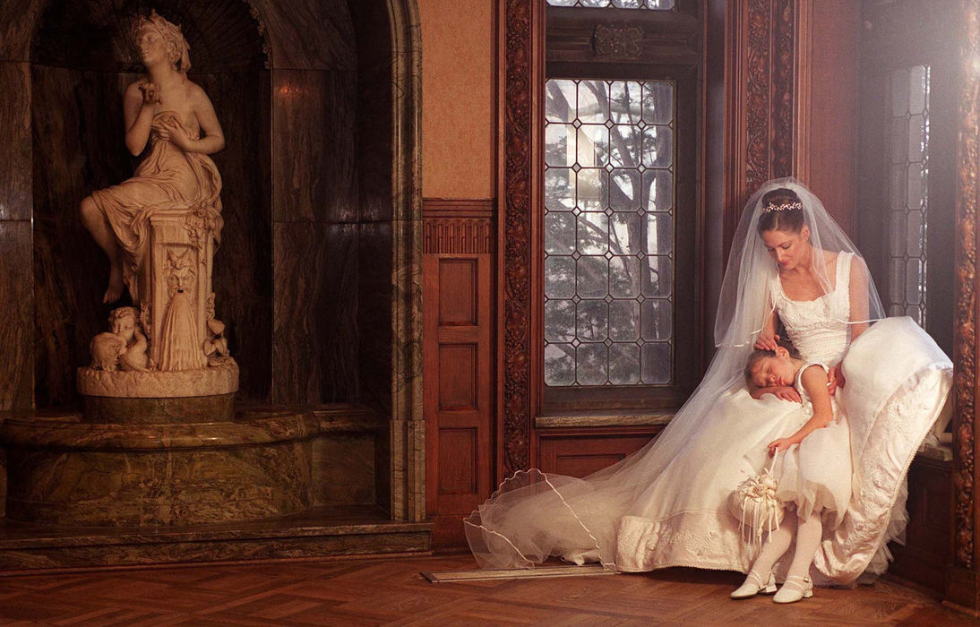 First Place, Photographer of the Year - Mike Levy / The Plain DealerThe bride is wearing a Ron LoVece silk organza gown with satin trim and handmade white and pink rose buds embellished with Venice lace ($5,450). The cathedral-length veil is trimmed with Venice lace ($325) by Allegro Design. The handmade rhinestone and silver leaf tiara ($435) is by Paris. The flower girl is wearing the Grace silk organza and satin dress ($250) by Joan Calabrese. Flower basket by Jessica Lynn ($70). 