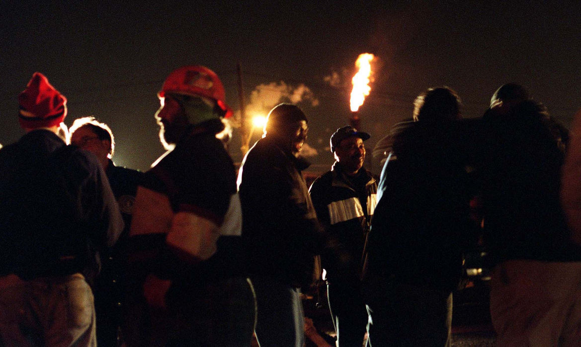 First Place, Photographer of the Year - Mike Levy / The Plain DealerFor more than one hundred years the stacks have billowed smoke and fire. Now LTV is closed and thousands of workers have lost their jobs.  The once enduring industry is dead. Steelworkers rally beside the blast furnace the night before a court would allow the company to close its business. Leaving thousands in the Cleveland area jobless.                                                               