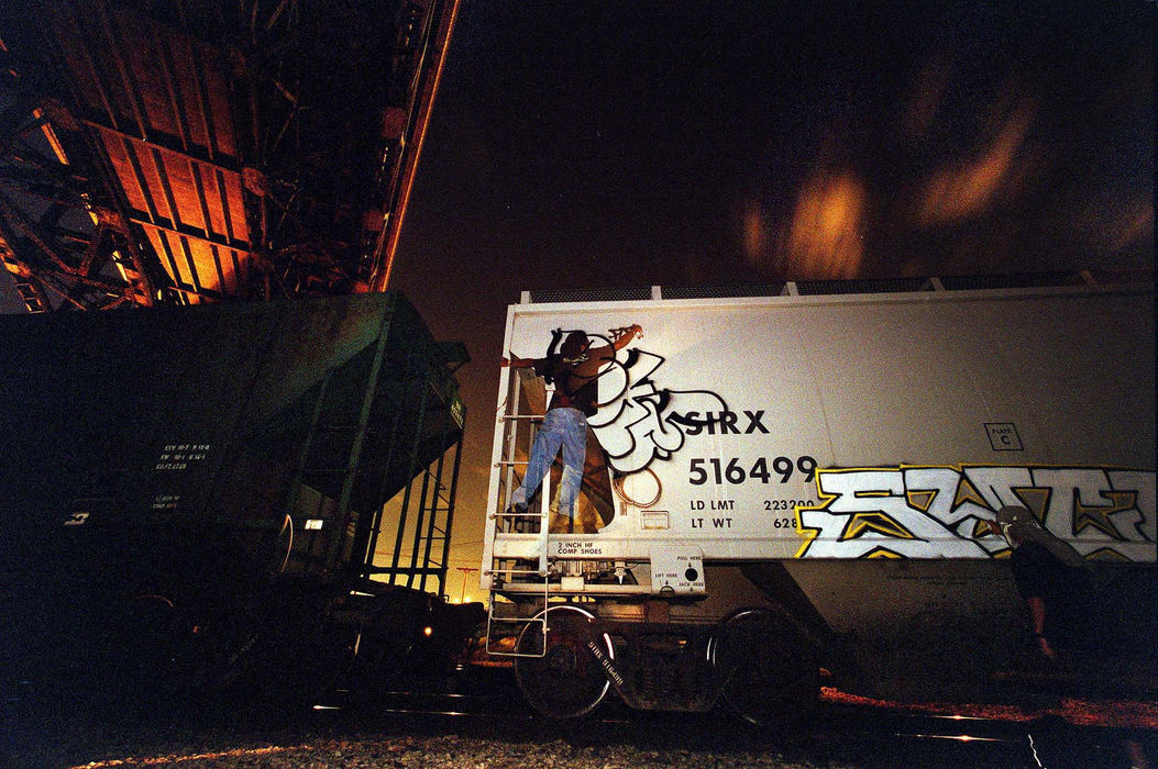 First Place, Photographer of the Year - Mike Levy / The Plain DealerPolk tags a freight parked under a bridge in the flats.  