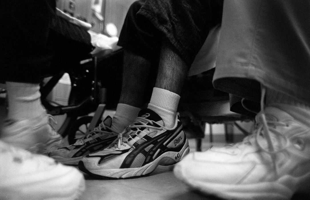 Second Place, Photographer of the Year - Steven M. Herppich / Cincinnati EnquirerKent still wears the shoes he used to run marathons. His father, Ervin and a nurse work with Kent at his bedside at the Drake Center. While training for his first triathlon on March 11th Kent was hit by a car. He suffered massive injuries including brain and spine damage. On September 11th as he watched the television during the terrorist attack Kent got very upset and spoke for the first time. 