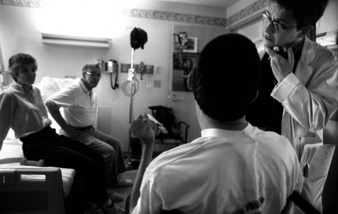 Second Place, Photographer of the Year - Steven M. Herppich / Cincinnati EnquirerA Father and his Son-Neurologist Dr. Susan Pierson asks Kent questions to get a sense of his comprehension of the events around him. Kent's sister Mary and father Ervin sit on his bed at the Drake Rehabilitation Center. While training for his first triathlon earlier this year Kent was hit by a car. He suffered massive injuries including brain and spine damage. 