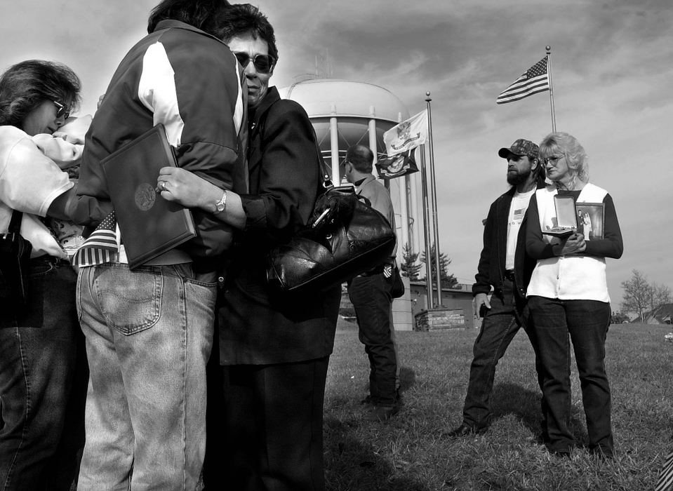 Second Place, Photographer of the Year - Steven M. Herppich / Cincinnati EnquirerVeteran Honored-David Doerflein and his sister Janet Zimmerman comfort each other at the grave sight of their father Floyd Doerflein, November 26, 2001. Congressman Steve Chabot presented the family a posthumous silver medal honoring their father for courage under fire while serving as an infantryman in France in 1944. His commander recommended him for the medal but it was never issued until Chabot's office untangled the red tape. Sister Kathy Helphinestine and her husband Tony stand on the right. 