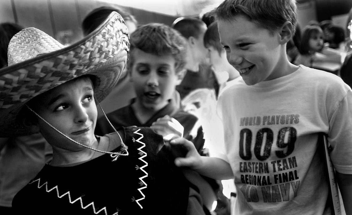 Second Place, Photographer of the Year - Steven M. Herppich / Cincinnati EnquirerYo quiero tu sombrero, amigo-Fourth graders Brian Price, R.J. Bowen, and Josh Milby joke around with each other during Harrison Elementary's Cultural Fair in the schools gym, December 18, 2001. Fourth graders at the school have spent the last three weeks learning about different cultures and ethnic groups, that culminated in this celebration for the kids, which included dance and foods from around the world. Brian dresses as a Mexican for the event. 