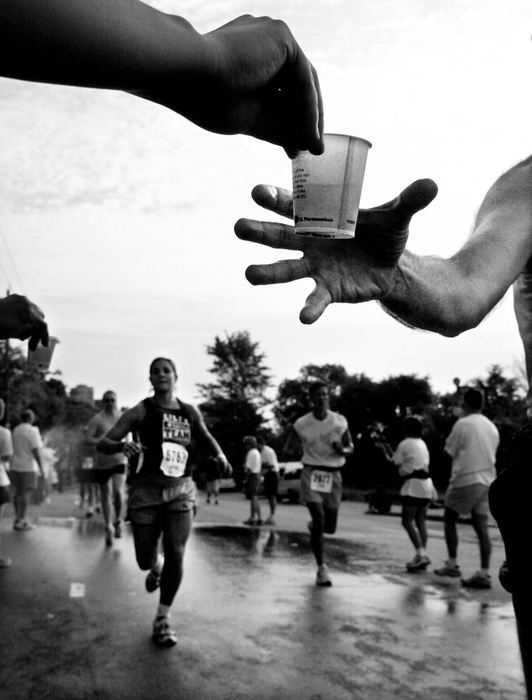 Second Place, Photographer of the Year - Steven M. Herppich / Cincinnati EnquirerMile 15-Runners grab glasses of water as they go by on Eastern Ave. at mile 15 of the Flying Pig Marathon in Cincinnati, May 6, 2001.