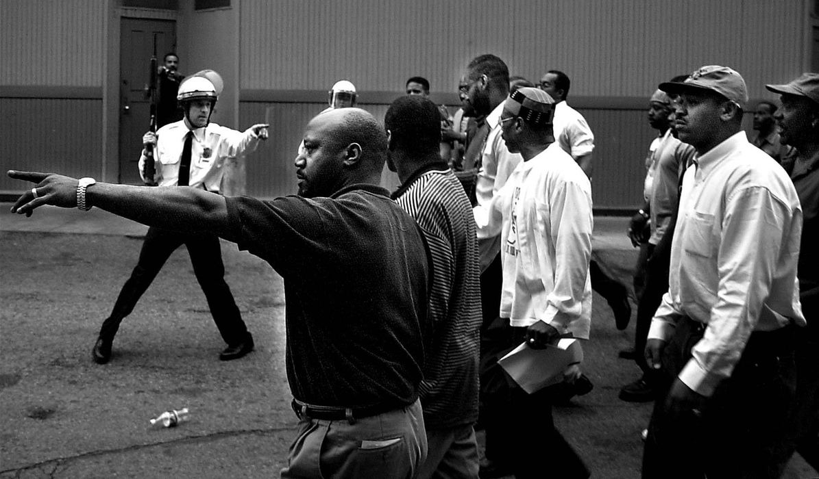 Second Place, Photographer of the Year - Steven M. Herppich / Cincinnati EnquirerCincinnati Police confront members of the New Prospect Baptist Church on Elm Street near Findlay market Tuesday night. Protestors rioted throughout the day into the night burning and destroying businesses as well as attacking both police and civilians. The shooting of Timothy Thomas lead to one week of protests, riots, and a city imposed curfew leading up to the funeral of this 19-year-old man.