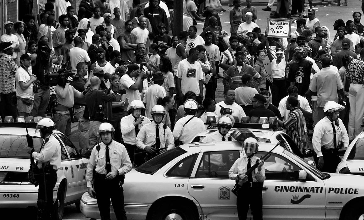 Second Place, Photographer of the Year - Steven M. Herppich / Cincinnati EnquirerPolice block a crowd gathered at 13th Street and Republic near the sight of the shooting of Timothy Thomas by a Cincinnati Police Officer. A Black Panther gathering was scheduled at the sight at 3:30 pm. Eventually the police backed off their vehicles and let the march commence. 