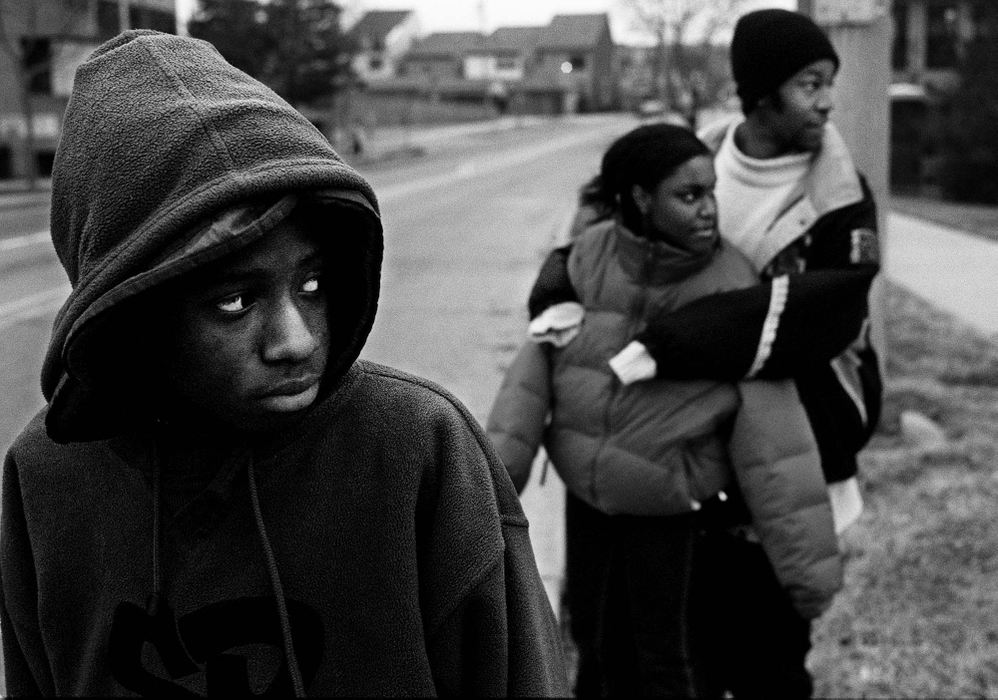 Second Place, Photographer of the Year - Steven M. Herppich / Cincinnati EnquirerThe Cincinnati Public School system suffers from a 50% drop out rate in their eight High Schools. Nearly 800 students attend Robert A. Taft High School in the West End of Cincinnati. If the recent past is any indication, most will not graduate. More than half the student body is in the ninth grade. Johnny Watson, a second-year student, waits for traffic to pass while walking to his bus after school. Johnny failed most of his classes last year, including English. 