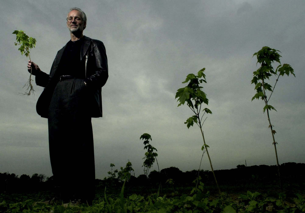 First Place, Portrait/Personality - Patrick Reddy / The Cincinnati EnquirerDeveloper with Seedlings-Land developer Paul Hemmer, holding   a red maple  seedling  on his 210-acre at Sand Run Nursery and Preserve. Hemmer has set a goal to plant 1 million trees in his lifetime. Hemmer's company constructs buildings in  industrial  parks.