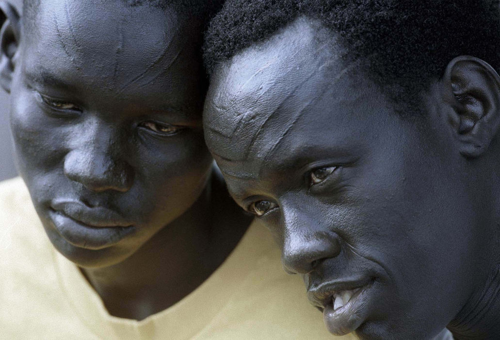 Second Place, Portrait/Personality - Lynn Ischay / The Plain DealerDaniel Nhial Peter (left) and James Matheer Akok are two of the 40 Sudanese men who arrived in Cleveland from a refugee camp in Kakuma, Kenya. Members of the Dinka tribe, they were scarified as part of a ceremony marking their passage from childhood to manhood. Each village has a different scarring pattern. 