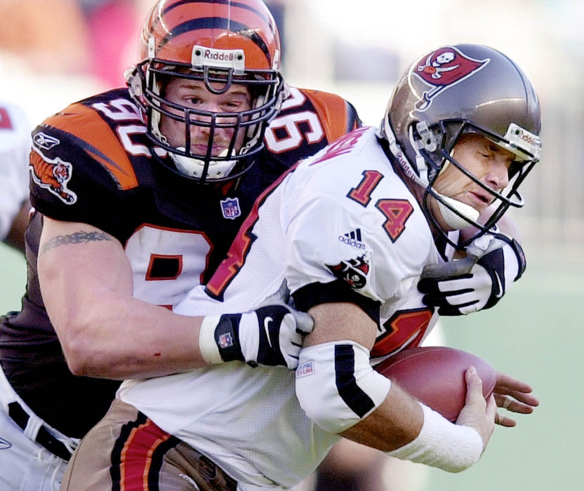 Third Place, Sports Action - Jeff Swinger / The Cincinnati EnquirerThe Cincinnati Bengals' defensive end Justin Smith sacks Tampa Bay Buccaneers' quarter back Brad Johnson in the first half of their game December 2, 2001 at Paul Brown Stadium in Cincinnati.