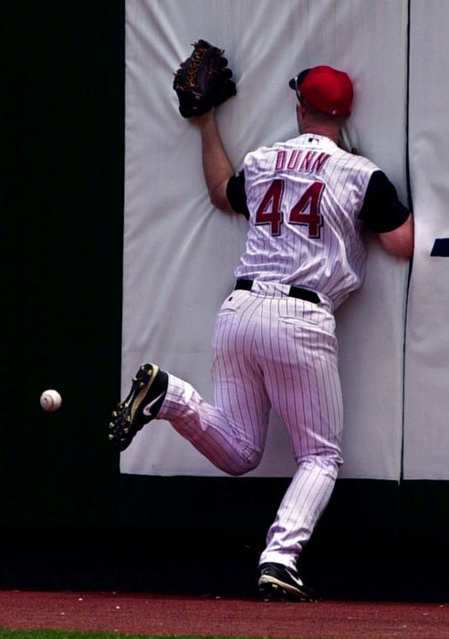 Award of Excellence, Sports Action - Brandi Stafford / The Cincinnati EnquirerCincinnati Reds' Adam Dunn slams against the right field wall while trying to run down a routine fly ball.