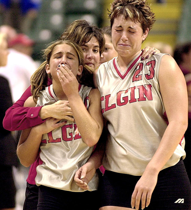 Award of Excellence, Sports Feature - James Miller / Marion StarElgin assistant coach Mikki Perry consoles Taryn Haas (left) and J.J. Thornberry after a gutty performance against Tucarawas Valley in Dayton. The Trojans held on to win in three games to advance to the Division III championship game.