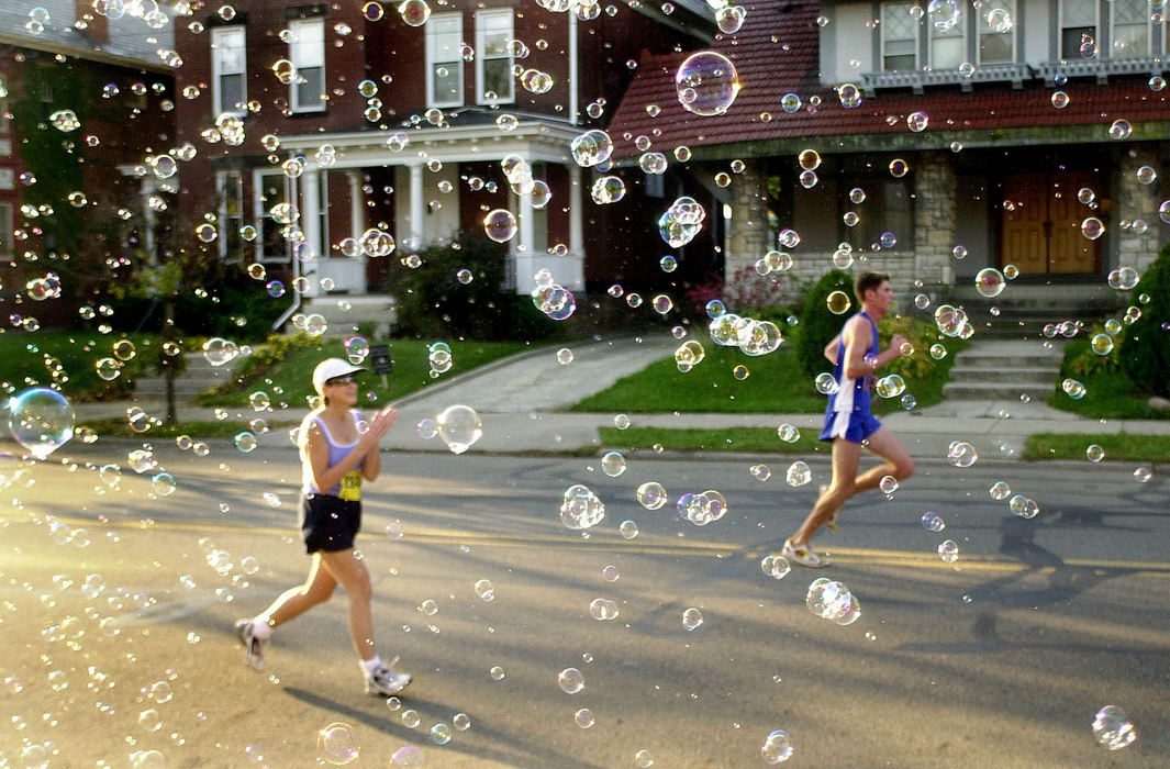 Award of Excellence, Sports Feature - Will Shilling / The Columbus DispatchBubbles float across Bryden Road as contestants in the Columbus Marathon head back into the downtown area after a leg of the race wound through Bexley. Encouragement from fans ranged from enthusiastic cheers and bubbles to live music. 