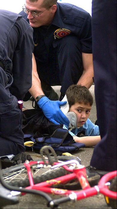 Second Place, Spot News Small Market - Marshall Gorby / Springfield News-SunMedics attend to Robert Givens, 8, of 329 N. Race St., who was injured at Cedar and Race streets in an accident. He was taken to Mercy Medical Center and transferred to Children''s Medical Center in Columbus. 