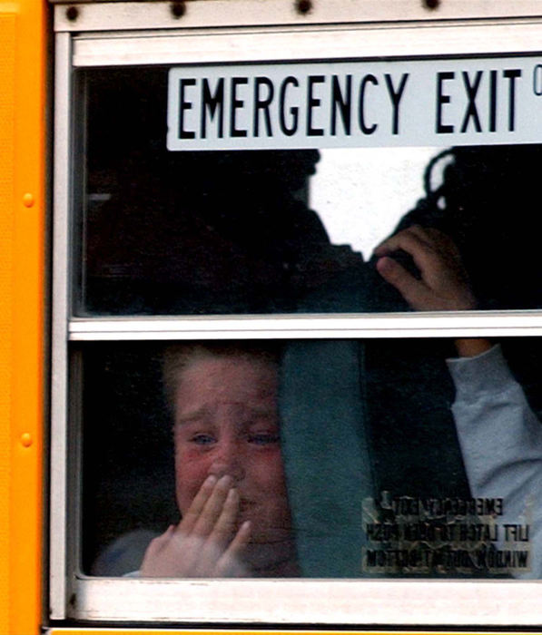 Award of Excellence, Spot News Small Market - Marshall Gorby / Spingfield News-SunA student from Northmont Schools is visibly upset as he watches from a bus window as Springfield Township firefighters from the Rockway Station remove a woman from a sport utility vehicle after it collided with the bus. 