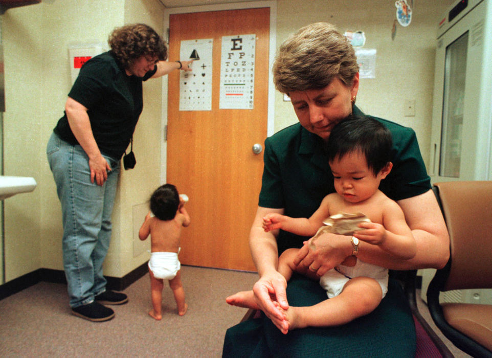 First Place, Student Photographer of the Year - David Distelhorst / Ohio UniversityJudy sits with Amy while Wendy and Ben look at an eye chart during a visit to the doctor. Wendy is a physician working part time in the emergency rooms of O'Bleness Hospital in Athens, Ohio and Camden Clark Hospital in Parkersburg, West Virginia.