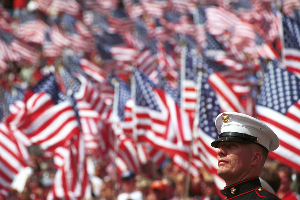 First Place, Student Photographer of the Year - David Distelhorst / Ohio UniversityUnited States Marine Corps Staff Sergeant Richard Bridgett of Springfield Ohio stands amongst a sea of American Flags at Ohio Stadium, Columbus, September 15, 2001 during the "Show You Care for the Victims and their Families" rally.