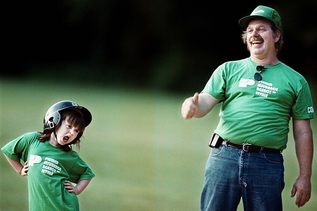 Second Place, Student Photographer of the Year - Greg Ruffing / Kent State UniversityNicole Rhoads, 5, yawns after reaching first base on a hit while head coach Mike Cogar gives a thumbs-up to another player for reaching third base on the play. The softball team is comprised of girls ages 4-7 who are getting their first taste of competitive sports. Coaching is also a first-time experience for Cogar. In dealing with new players, Cogar says the emphasis is not on winning, but rather on sparking an interest in the sport and developing the players' abilities.